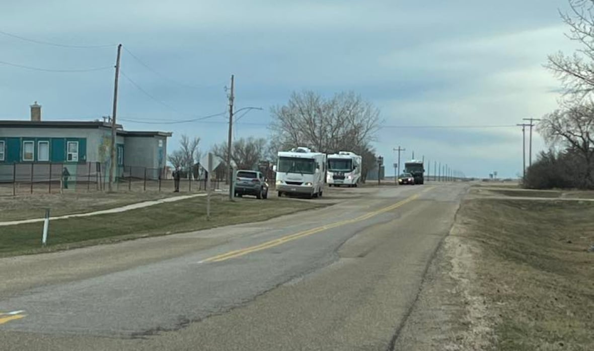 RVs parked by an old school.