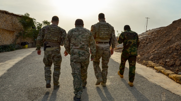 Former soldiers say they fear Iraqi trainees committed war crimes with allies' weapons; Two Canadian soldiers and two Kurdish Peshmerga fighters, who were being trained and mentored by Canadians in northern Iraq, walk up a hill near Mosul in November 2016\.