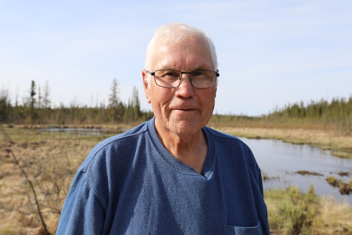 A man in a blue shirt.