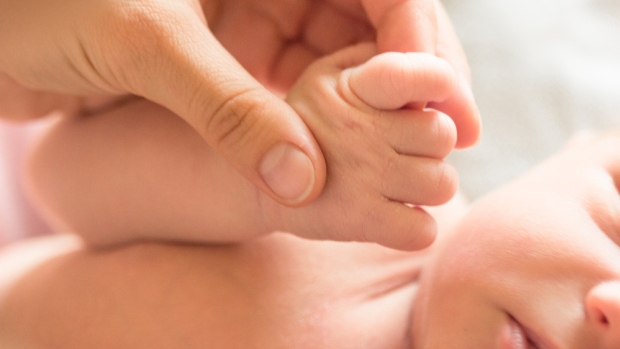 The results are in: N.B.'s most popular baby names of 2023; A mother holds her newborn's hand\.
