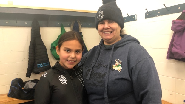 Unseasonably warm temperatures leave winter athletes in Fort Simpson, N.W.T., in the lurch; Fort Simpson speed skating coach Val Gendron poses for a picture with skater Serena Hanna\. Gendron Says that sports like speed skating are an opportunity for kids in the community to connect and work on leadership skills\.