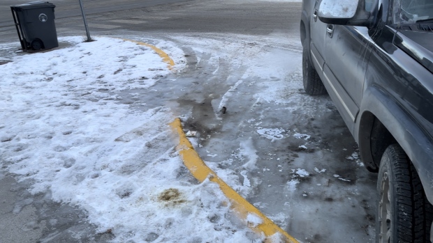 Whitehorse residents with disabilities threaten class-action over city's lack of snow-clearing; Icy conditions near an accessible parking space at 4th Avenue and Wood in downtown Whitehorse\. Larochelle says frozen, snow-covered ramps like this one are extremely challenging to navigate by wheelchair\. 