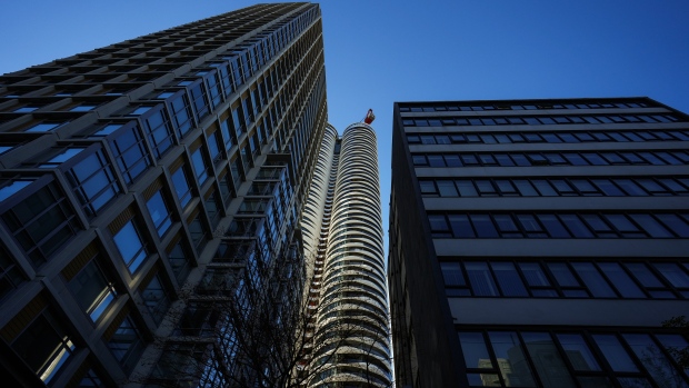Heat pumps are hot items. But for people living in condos, getting one presents some challenges; The Butterfly condo tower, back centre, is seen under construction framed by existing buildings, in Vancouver, on Thursday, November 23, 2023\. A Desjardins report released last week said short-term rentals likely contributed to the housing affordability crisis in Canada\.