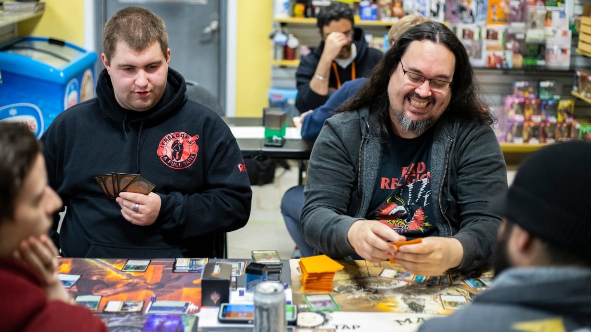 A group of men play a card game.