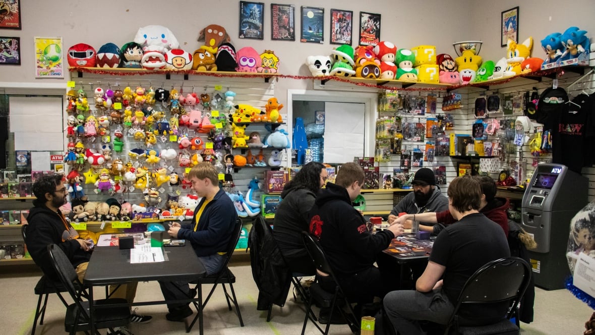 A group of people play card games.