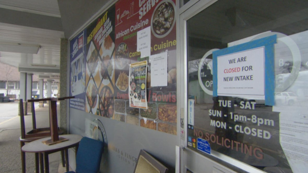 A sign that reads "WE ARE CLOSED FOR NEW INTAKE" alongside other, unrelated signage.