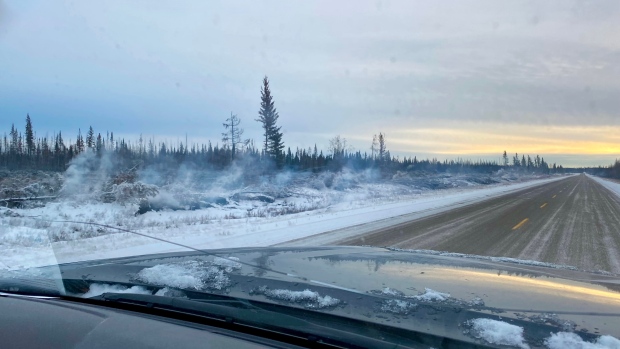 Smoking snow shows 'holdover fires' still burning in N.W.T. — but not a danger right now, says fire scientist; Smoke drifts upward from snow along the side of Highway 1 near Enterprise, N\.W\.T\., in early December 2023\.