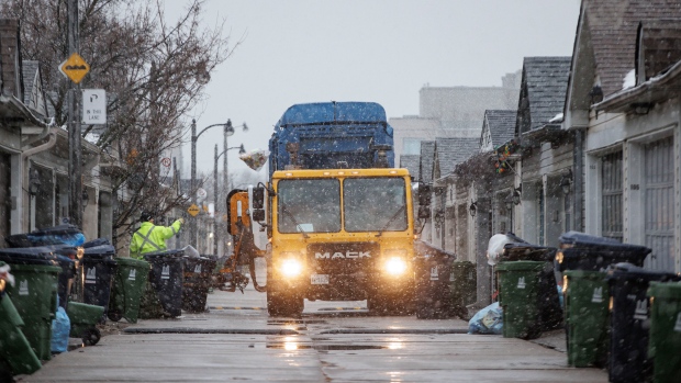 Recycling is failing as a way to reduce plastic. Here's why; A worker collects recycling in a Toronto alley during a wet snowfall on Jan\. 9, 2024\.