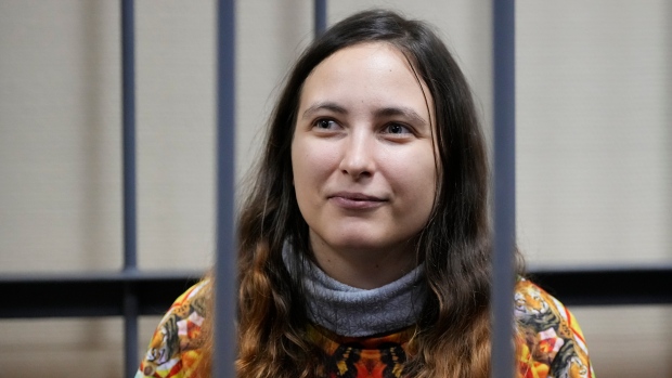 Imprisoned for protesting Ukraine war, this Russian woman uses letters, art to describe life in detention; Sasha Skochilenko, a 33-year-old artist and musician sits behind bars in the court room as she waits for a hearing in the Vasileostrovsky district court in St\. Petersburg, Russia, Nov\. 13, 2023\. She's charged with spreading 'false information' about the Russian army\.