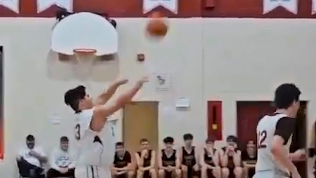 He scored 4 three-pointers in 3 minutes — while the opposing team cheered him on; Cameron Power shoots a three-point shot for his team, the Mobile High Monarchs\.