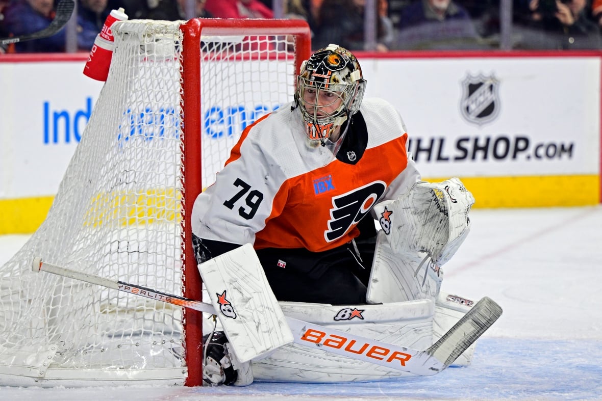 A hockey goalie looks to make a save.