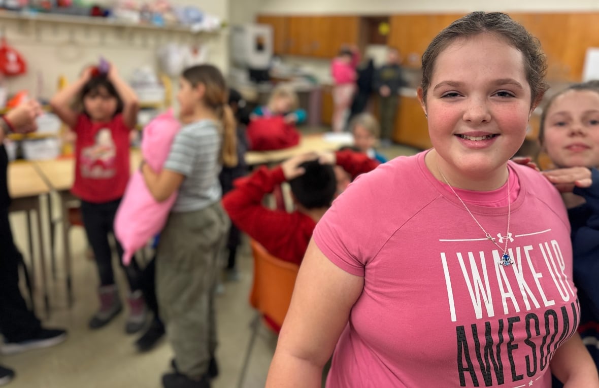 A girl smiles at the camera. 