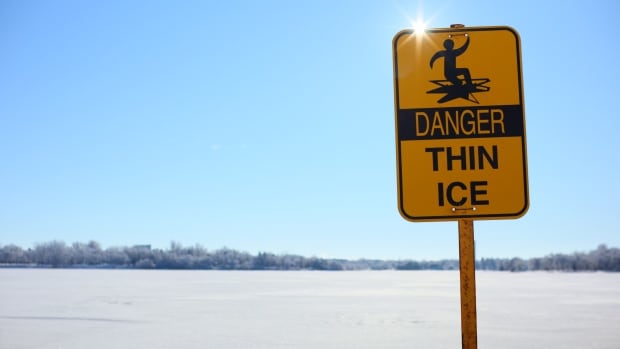 A thin ice sign at Wascana Lake in Regina on Feb. 1, 2024. A yellow warning sign with the phrase "DANGER: Thin Ice"