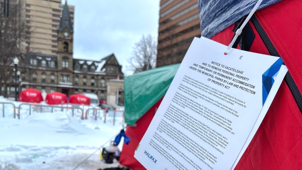 Halifax starts cleaning up encampment sites; A notice from the Halifax municipality is shown attached to a tent in Grand Parade in Halifax on Wednesday, Feb\. 7, 2024\.