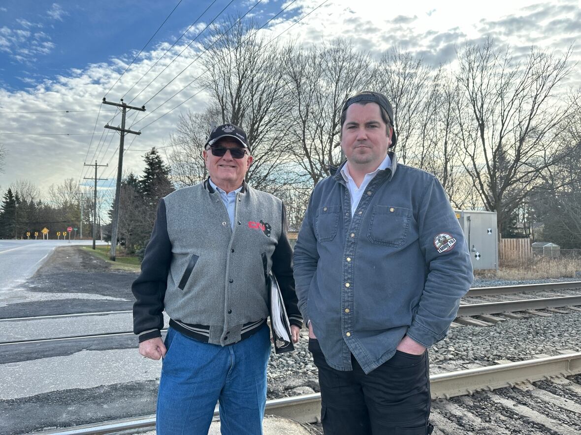 Retired CN employee Jim Crane, left, and Thames Centre Coun. Tom Heeman, right, say the Shaw Road railway crossing in Dorchester is in such bad shape that's it's become a safety concern for drivers. 