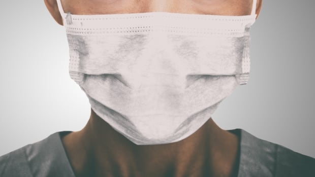 A health care worker wearing a medical mask against COVID-19. A health care worker wearing a medical mask against COVID-19.