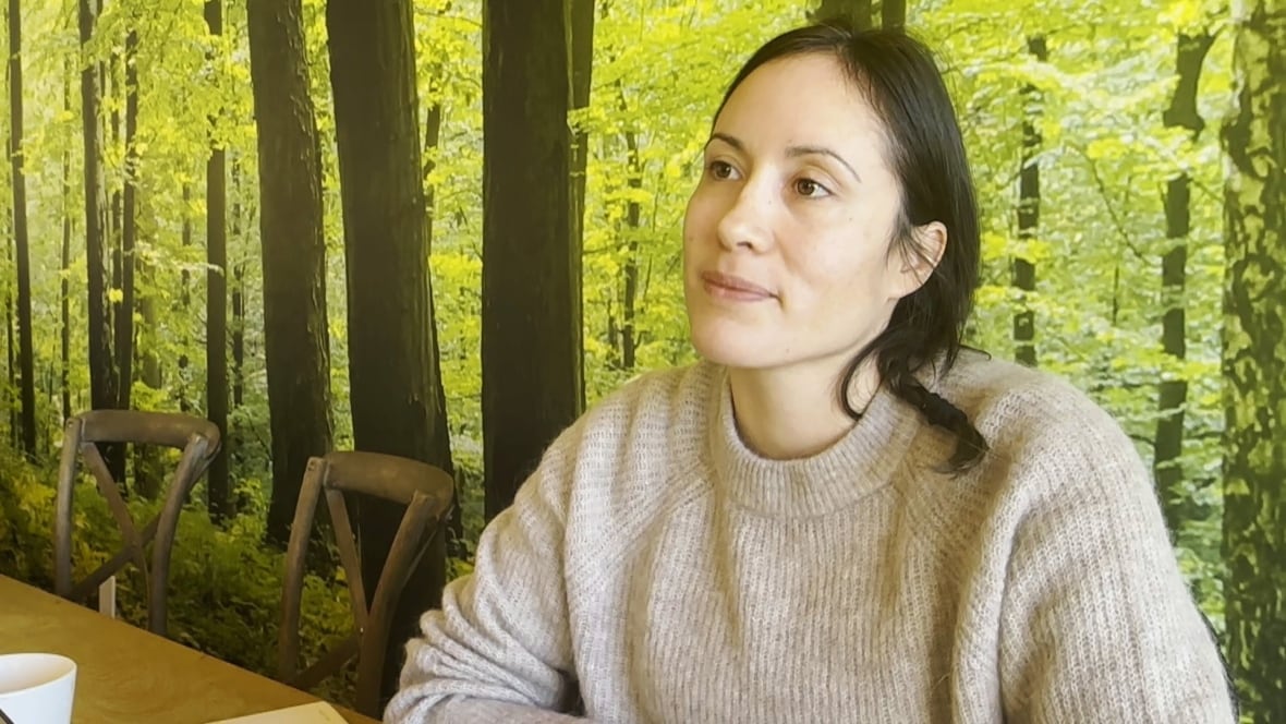 A woman sitting down at a table.