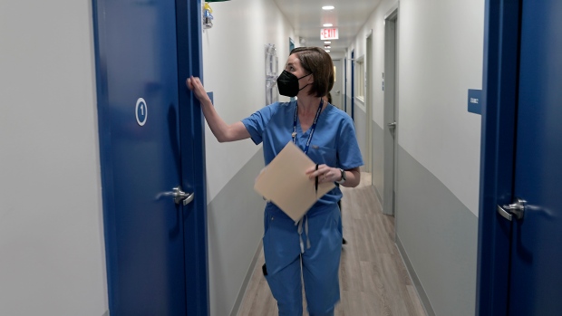 Massive new survey finds widespread frustration with access to primary health care; A doctor enters an exam room consult with a patient\.
