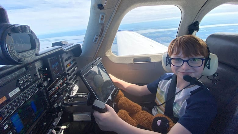 Smiling little boy in a plane cockpit.