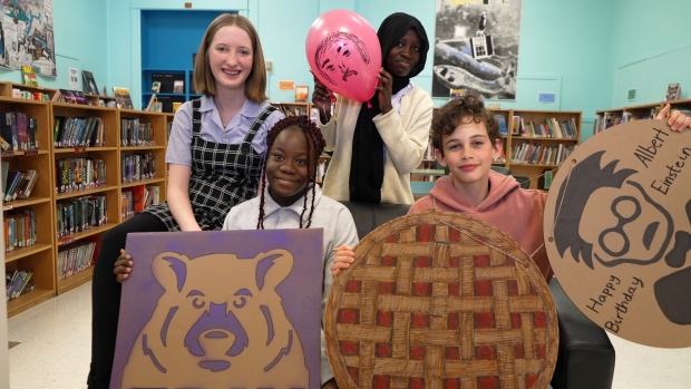 Eating pie or reciting Pi, whatever you prefer, Pi Day has something for everyone; From back left to right, Grade 8 students Joanna Dinan, Fahizah Oyetola, Esther Olawumni and Jonah Myles all celebrated Pi Day at George Street Middle School\.