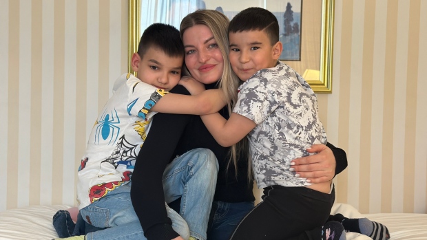 Final rush of Ukrainians arrive in Nova Scotia ahead of emergency visa deadline; Iryna Lichna with her sons, Samir \(left\) and Saleem, in a hotel room in Halifax where they've been staying since they fled Ukraine for Canada\.