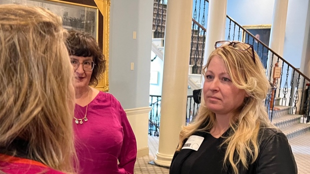 Sexual assault survivor says N.S. bill would give government too much access to patient records; From left,  Liberal MLA Kelly Regan, back to camera, NDP MLA Lisa LaChance and Carrie Smith in conversation after Smith's testimony to a committee of MLAs in Halifax on Monday, March 24, 2024\.  