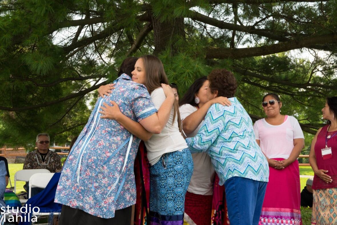 Women embracing.