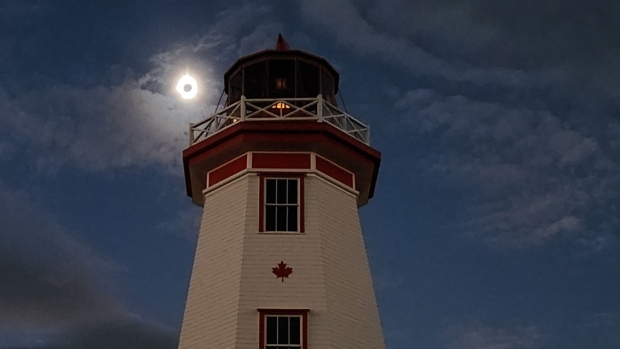 People share their favourite photos of the solar eclipse over P.E.I.; The eclipse darkens the lighthouse in Tignish\.