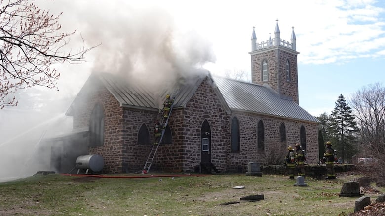 A stone brick church with smoke coming out of the ceiling