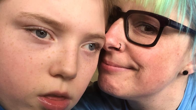 A boy is pictured with his mom