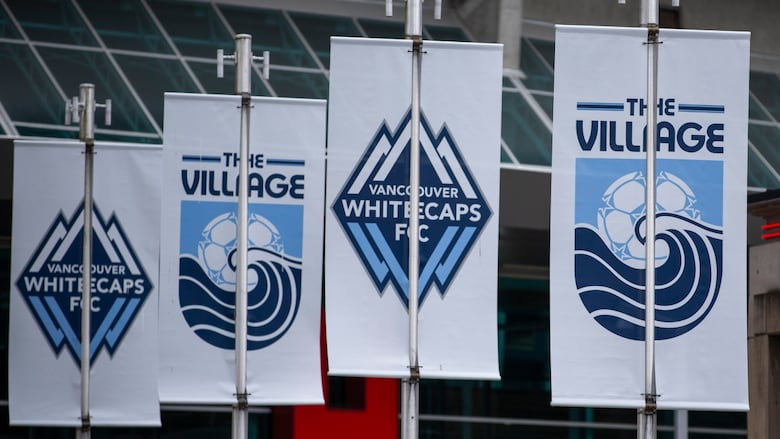 A series of banners with the Vancouver Whitecaps logo and 'The Village.'