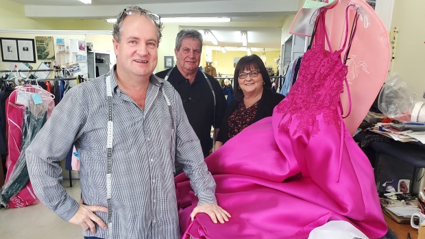 How a stowaway gave birth to a tailor shop that's still going 60 years later; From left, Mike, Tony Jr\., and Theresa at Tony's Tailor Shop on Freshwater Road\. Mike is working on a prom gown\. 'I was gonna tell you a tailoring joke but I ran out of material,' he says\. 