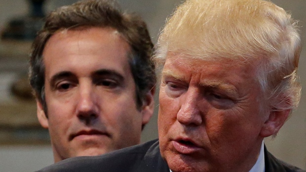 Trump trial nears final phase with key witness: confidant-turned-nemesis Michael Cohen; Republican presidential nominee Donald Trump's personal attorney Michael Cohen stands behind Trump as a group of supporters lay hands on Trump in prayer during a campaign stop at the New Spirit Revival Center church in Cleveland Heights, Ohio, U\.S\. September 21, 2016\. Picture taken September 21, 2016\. REUTERS/Jonathan Ernst