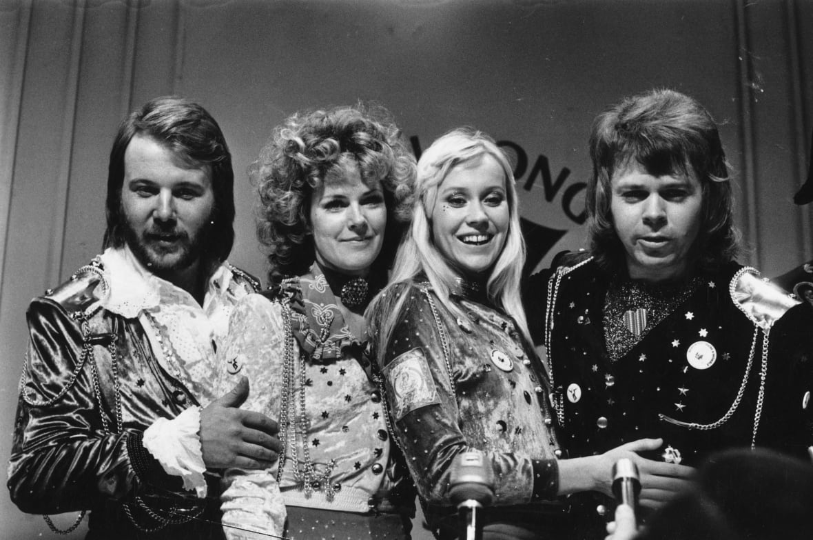 Pop group members smile and put on a picture.