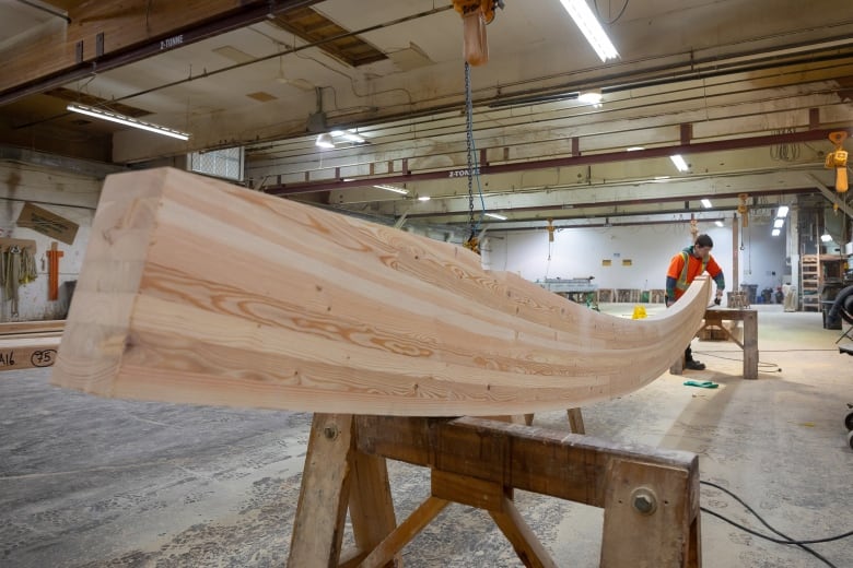 A piece of curved, glue-laminated timber is pictured at the Mercer Mass Timber factory in Okanagan, B.C.