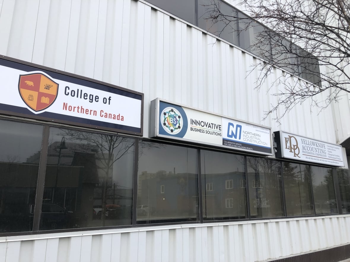 Three signs on the side of a building. 