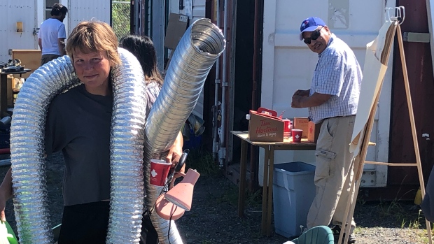 Yellowknifer who kept ReStore afloat says closure this year is 'awful timing'; Shannon Jennings at the ReStore with some of her finds: ducting and a desk lamp\.