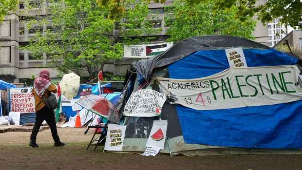 Pro-Palestinian encampment members reject McGill's 'laughable' latest offer; A person walks past the pro-Palestinian encampment on McGill University campus, in Montreal on May 13, 2024\.