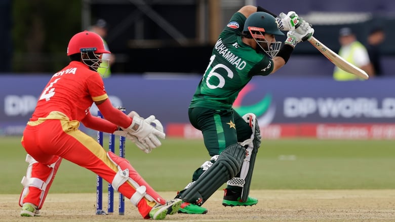 Cricket player bats during a match