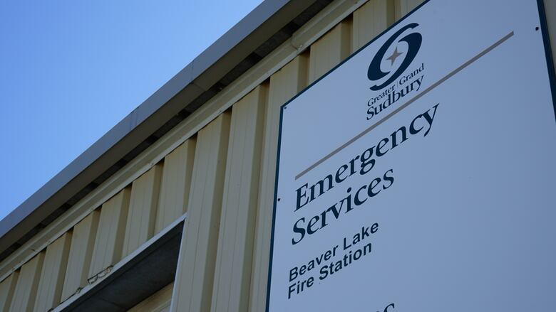 A sign that reads 'emergency services' on a building.