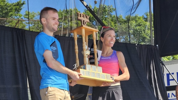 Here are the Tely 10 race winners: First time for one, 8th win for another; Callum Drever and Kate Bazeley accepting their awards for each coming in first in the Tely 10 race in their gender category\. 
