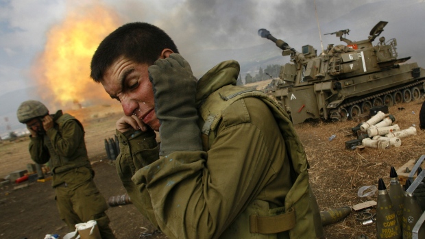 Canadian military planning for evacuation of 20,000 from Lebanon, says top commander; Israeli soldiers cover their ears as an artillery unit fires shells towards southern Lebanon from a position near Kiryat Shmona in northern Israel, near the border with Lebanon, on Friday, July 21, 2006\. In the last 24 hours, at least six Israeli troops have been killed in pitched battles with Hezbollah militants and an Israeli helicopter pilot was killed when two Apache attack helicopters collided\.
