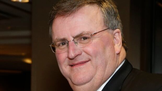 Kent Oakes, who died as a result of a traffic accident on Friday, is being remembered as a leader in the harnessing racing industry. Man with glasses in a business suit.