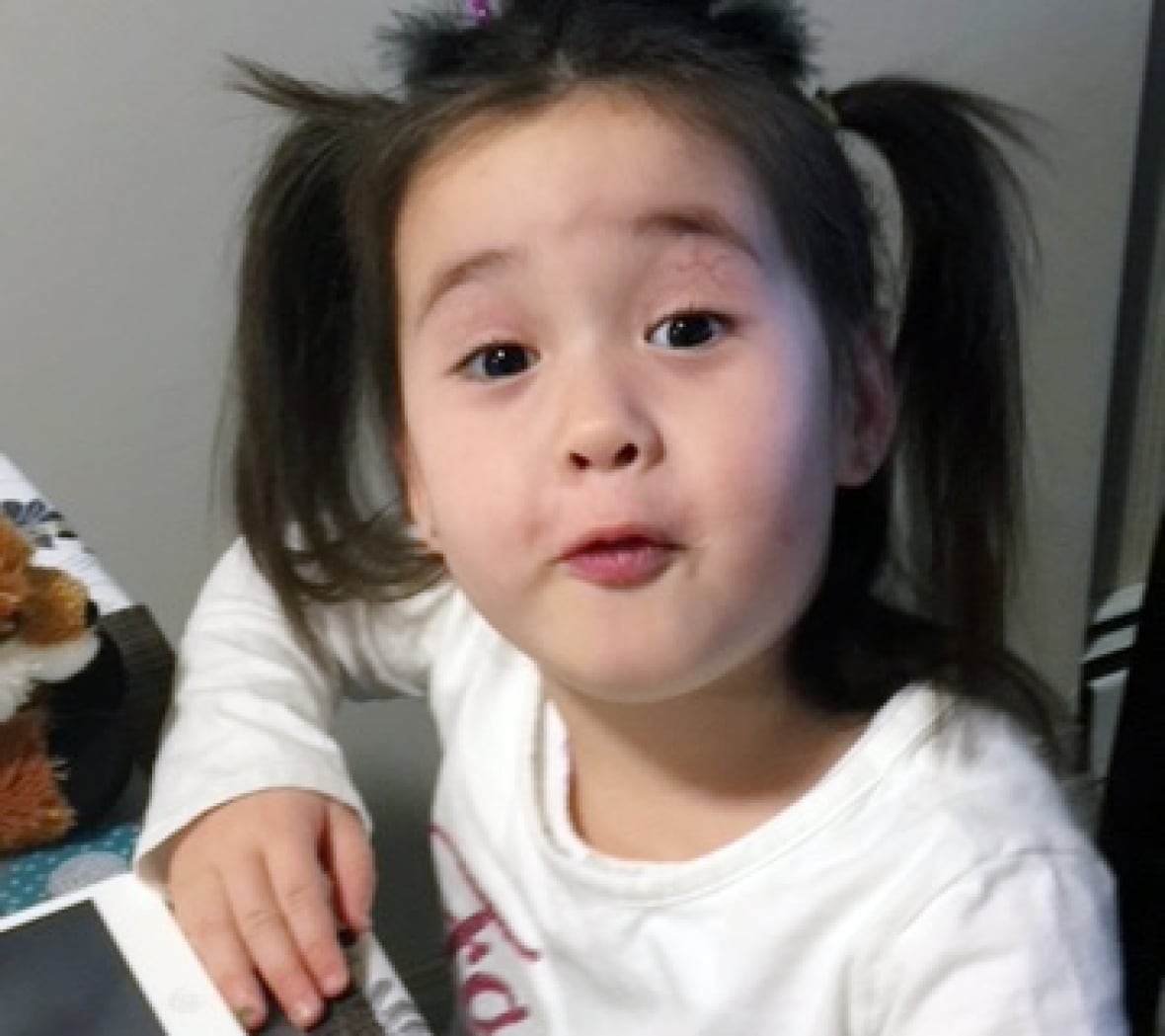 A young girl with a sparkly purple Halloween headband.