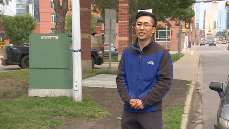 Jason Wang standing by missing sidewalk link.