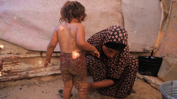 With a lack of access to aid, this mother in Gaza bathes her child with sand; The mother of four says she can't access basic hygiene products to bathe her children and has had to resort to using a mix of sand and water to rub on their bodies to keep them clean\. 