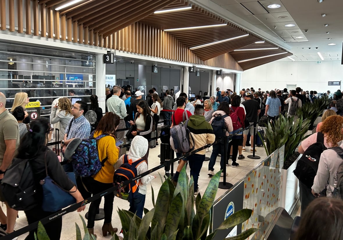 A line of travellers at Pearson International Airport in Toronto. The airport advised passengers flights could be delayed or cancelled Friday after a global outage of Crowdstrike cybersecurity software.