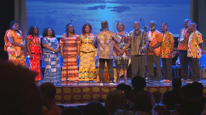 People sing on a stage.
