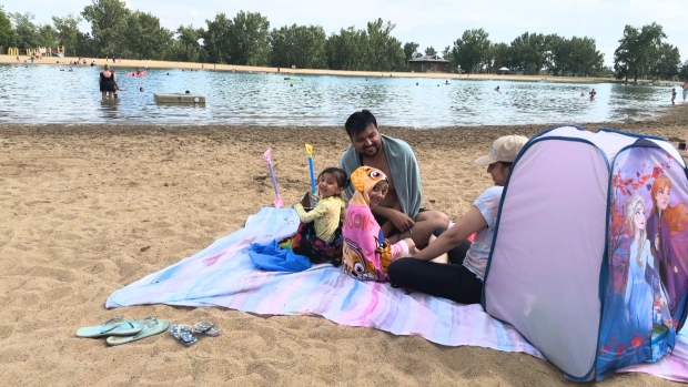 Is that water clean? Here are the best beaches getting tested around Calgary; Faraz Siddiqui and Syeda Ahmad, right,  said they enjoyed Sikome Lake for the first time in years recently\. They took their children Aira, 5, in the hooded towel and Minnah, 2\.