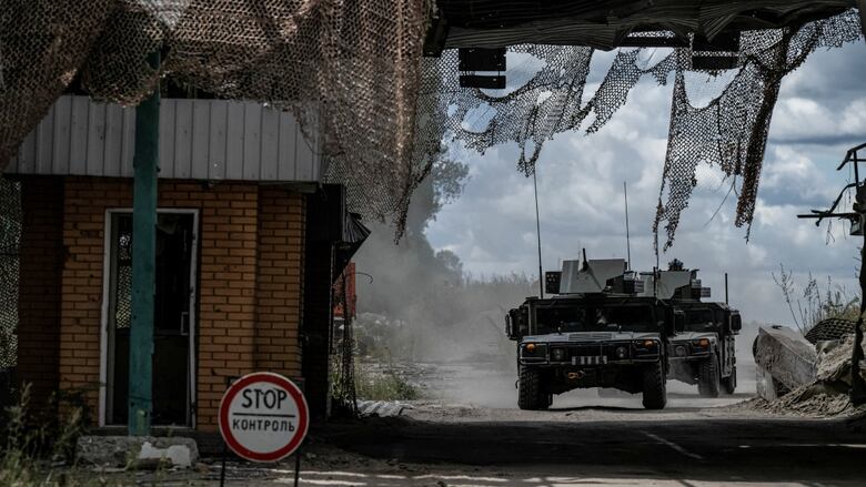 Two Ukrainian tanks driving on road near Russian border crossing point
